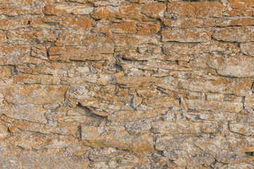 Old stone wall texture with moss