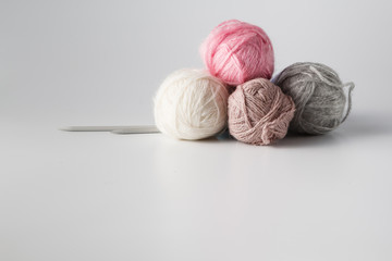 Fototapeta na wymiar Clews of colored yarn with needle
