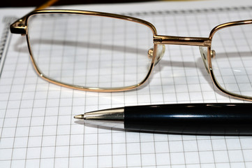 glasses pen notebook