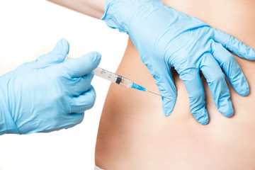 lifting injection in stomach  for young woman closeup