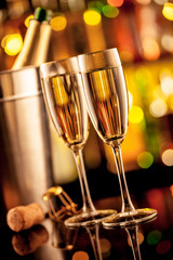 Glasses of champagne on bar counter