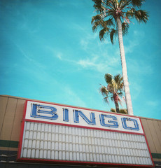 Obraz premium aged and worn vintage photo of bingo hall and palm trees