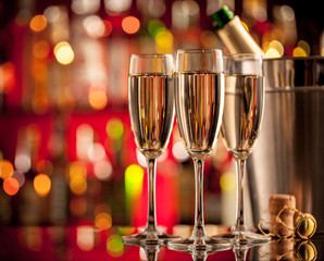Glasses of champagne on bar counter