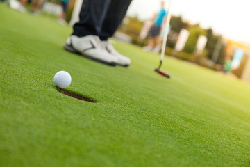 Golf player at the putting green