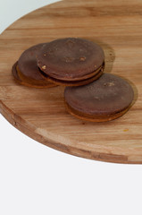 Three chocolate roung biscuits on the wooden board
