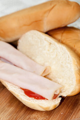 Sandwich turkey smoked ham tomato ketchup wooden board