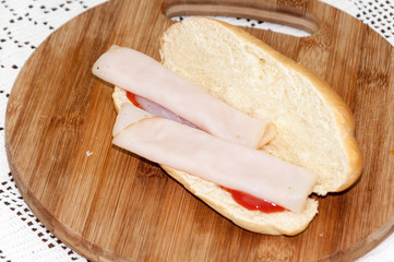 Sandwich turkey smoked ham tomato ketchup wooden board