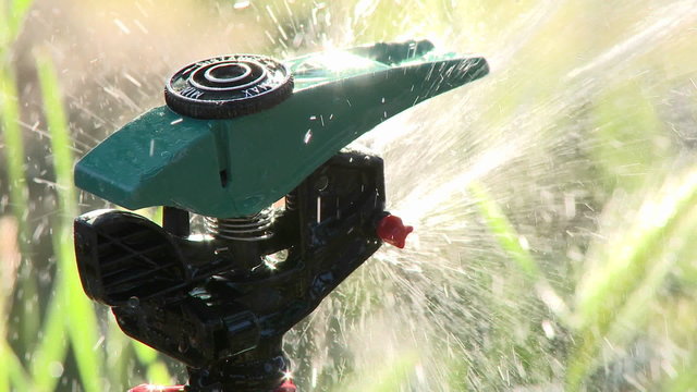 Close-up Rack Focus On A Sprinkler Spraying Water In Oak View, California.