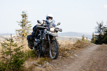Fototapeta na wymiar Motorbiker travelling in autumn mountains