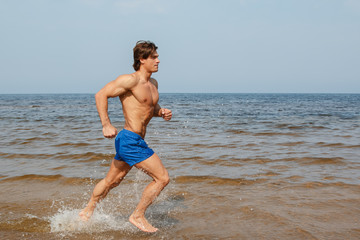 Fototapeta na wymiar Man during jogging by the sea coast