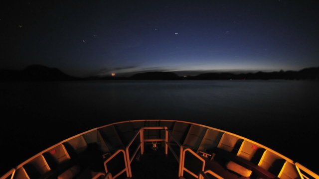 Point of view time lapse of a ship leaving Sitka at night and cruising up Olga Strait in Southeast, Alaska.