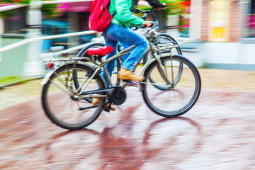 Fototapeta premium Radfahrer bei Regenwetter in Bewegungsunschärfe