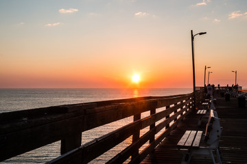 Orange Sun at Dawn at the Virginia Beach fishing pier. 