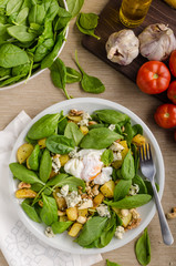 Spinach salad with egg benedict