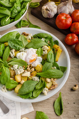 Spinach salad with egg benedict
