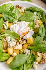 Spinach salad with egg benedict