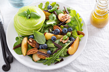 Fresh healthy salad with greens and apple