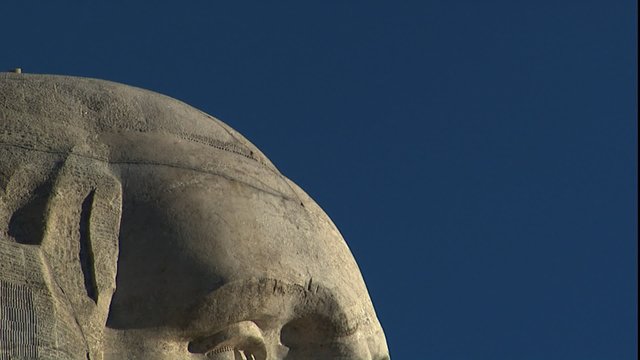 Slow tilt down to CU of Mt. Rushmore faces