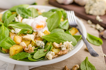 Spinach salad with egg benedict
