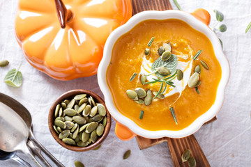 Pumpkin soup with cream, herbs and seeds