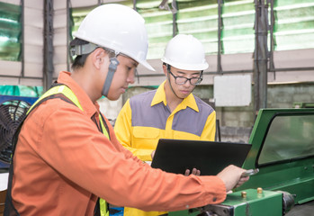 Fototapeta premium Asian Mechanical Engineer using computer-aided to do planning an