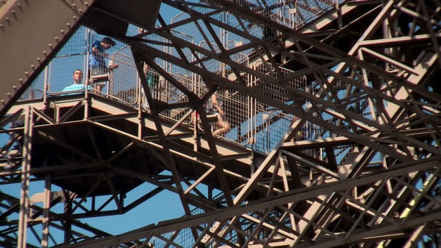 Tourists walk on the Eiffel Tower in paris.