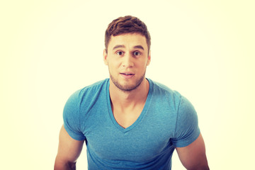 Obraz premium Young handsome guy surprised.