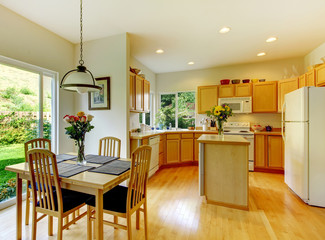 Wooden golden kitchen interior with dining room