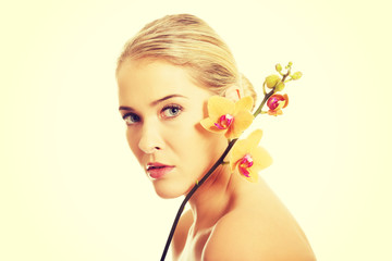 Beautiful spa woman with orange orchid