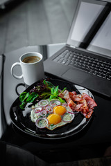  Eggs, coffee near laptop.