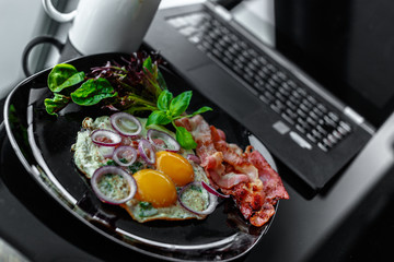  Eggs, coffee near laptop.