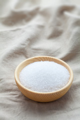 Fototapeta na wymiar white sugar in a wooden bowl