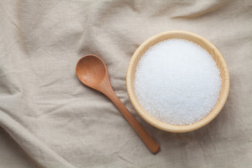 white sugar in a wooden bowl