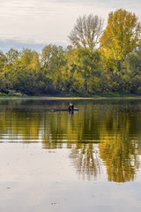 Рыбак в лодке на реке осенью. Россия,Сибирь,Новосибирская область,Колыванский район,река Чаус