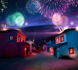 Scale model of a typical mexican village at night with fireworks