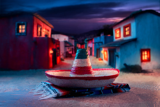 Mexican hat "sombrero" on a "serape" in a mexican village at twi