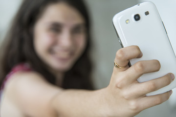 Girl taking a selfie with her phone