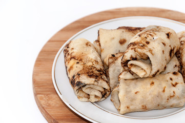 Stuffed rolled pancakes with sour cream fried bacon