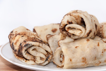 Stuffed rolled pancakes with sour cream fried bacon