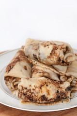 Stuffed rolled pancakes with sour cream fried bacon