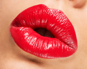 Woman's lips with red lipstick and  kiss gesture