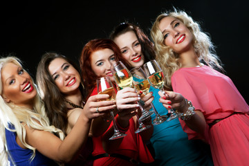partying girls clinking flutes with sparkling wine