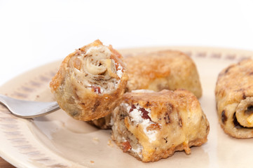 Slice of stuffed pancake on the metal fork