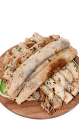 Rolled and stuffed pancakes on the plate