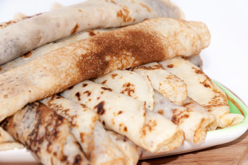 Rolled and stuffed pancakes on the plate