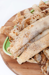 Rolled and stuffed pancakes on the plate