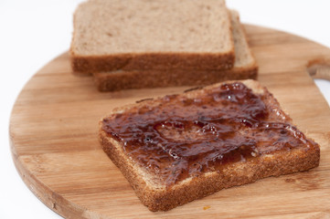 Fototapeta na wymiar Strawberry jam on bread