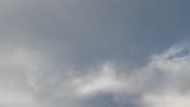 Clouds blow past a peak eventually cover it