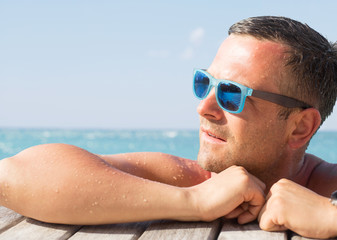 Young handsome man wearing sunglasses