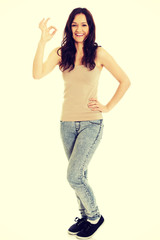 Fototapeta premium Young woman showing perfect sign.